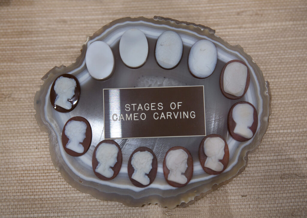 12 ovals showing how a cameo is carved attached to Brazilian agate slab.