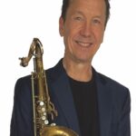 David Polk holding his saxophone.